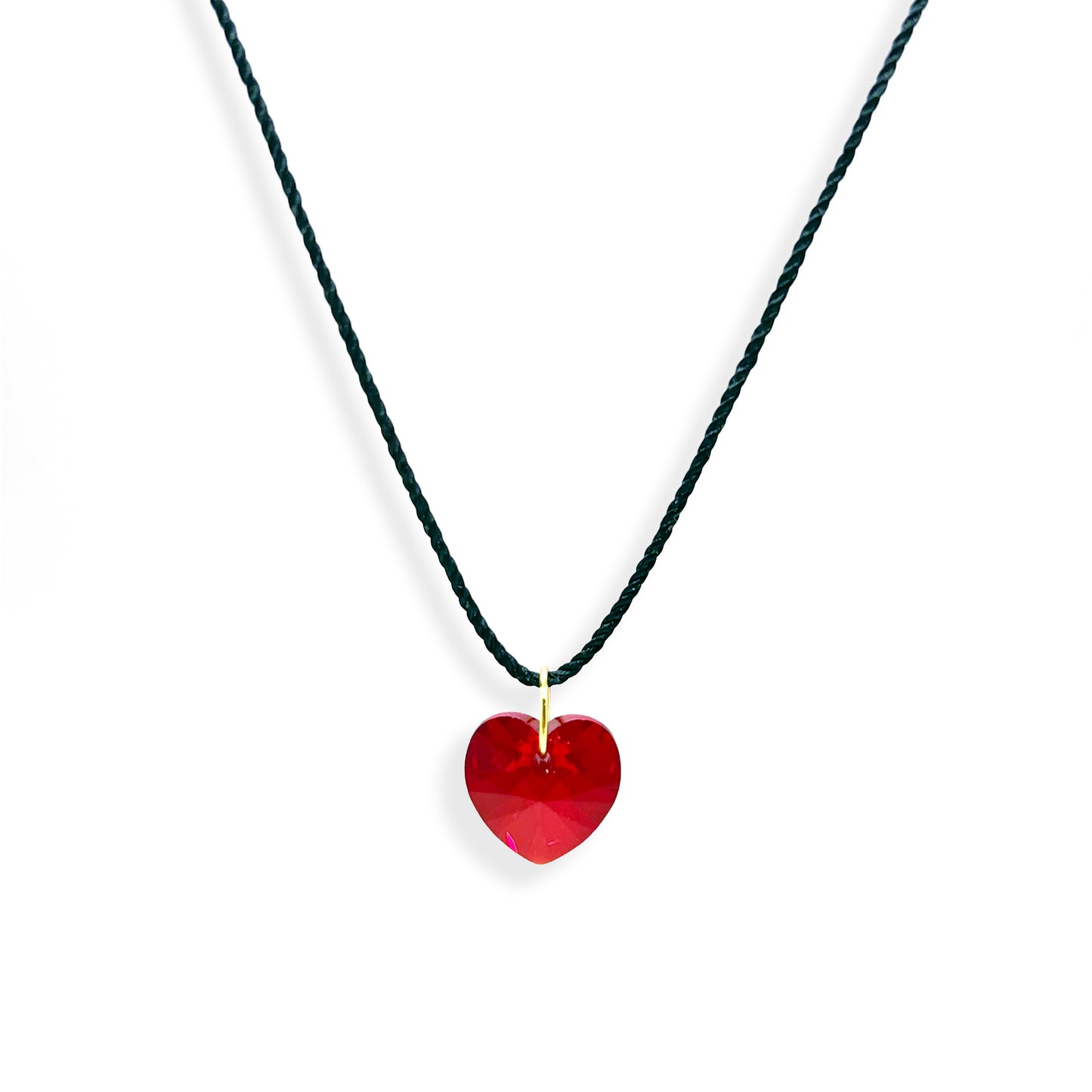 This stunning Swarovski red heart pendant is the perfect way to express your affection. The sparkling red crystal is accentuated by a lovely black thread, making it an eye-catching piece of jewelry. Whether you're gifting it to a loved one or treating yourself, this pendant will make a special statement. 11:11 collection, Ace Studio