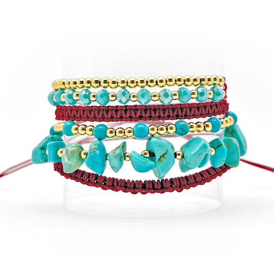 A 6in1 wrap bracelet featuring gold plated beads, turquoise beads, and a red burgundy thread. The bracelet is wrapped around a wrist multiple times, creating a layered and textured appearance. The gold beads add sophistication while the turquoise beads bring vibrancy to the design. Suitable for any occasion, this unique bracelet is a great addition to any jewelry collection.